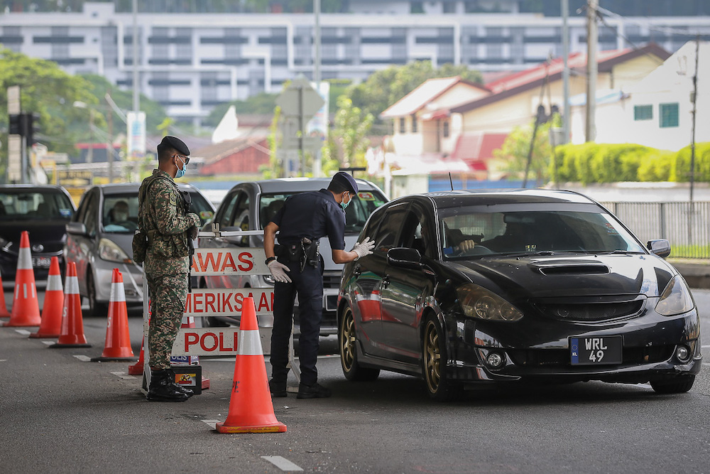 Police and Armed Forces personnel conduct a check on vehicles at a roadblock at Jalan Klang Lama in Petaling Jaya July 4, 2021. u00e2u20acu201d Picture by Yusof Mat Isa