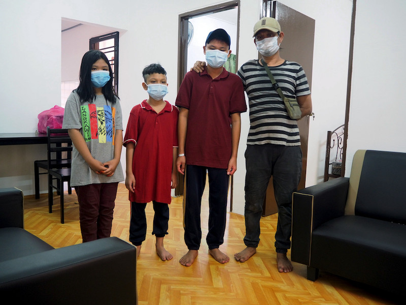 Syed Sidiq Abudin Syed Abdul Aziz (right) with his three children at their new rented home in Kampung Padang, Melaka July 3, 2021. u00e2u20acu201d Bernama pic 