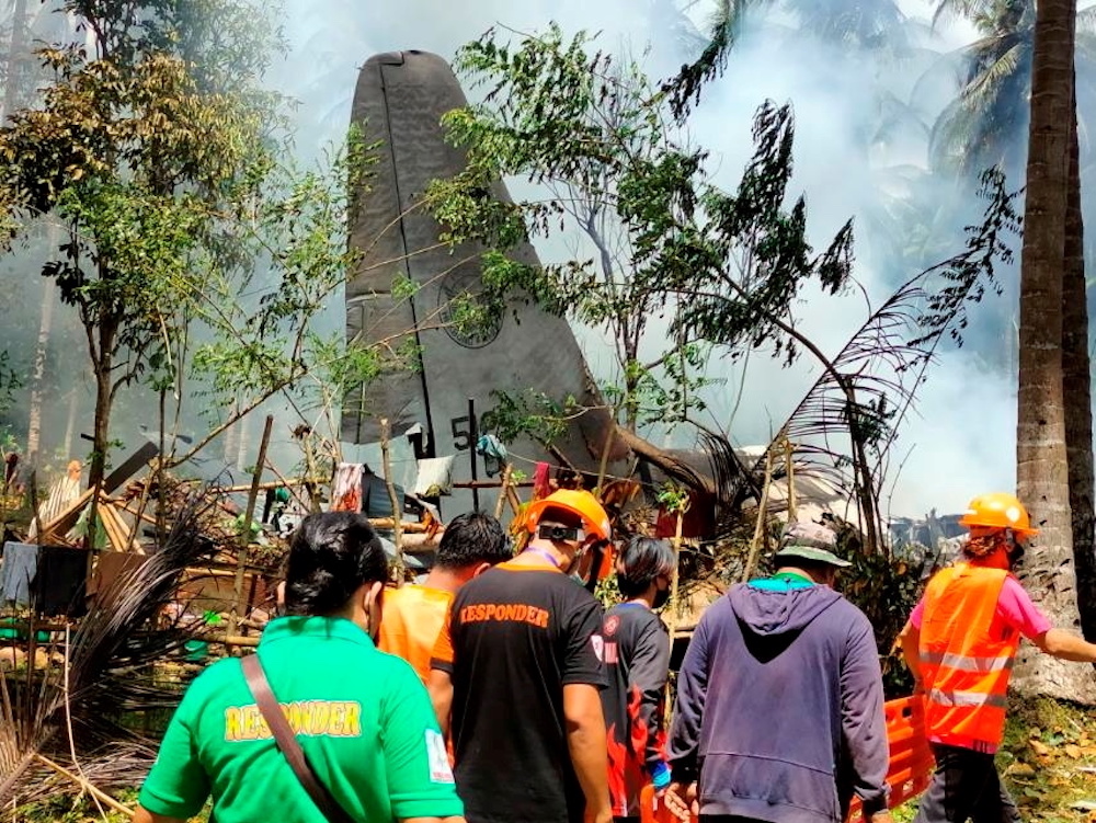 First responders work at the site after a Philippines Air Force Lockheed C-130 plane carrying troops crashed on landing in Patikul, Sulu province, Philippines July 4, 2021. u00e2u20acu201d Armed Forces of the Philippines-Joint Task Force Sulu/Handout via Reuters