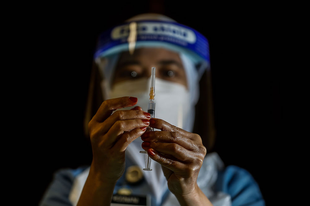 A nurse prepares the vaccine during the vaccination session for Persons with Disabilities in St Nicholas Home, Bagan Jermal July 5, 2021. u00e2u20acu201d Picture by Sayuti Zainudin