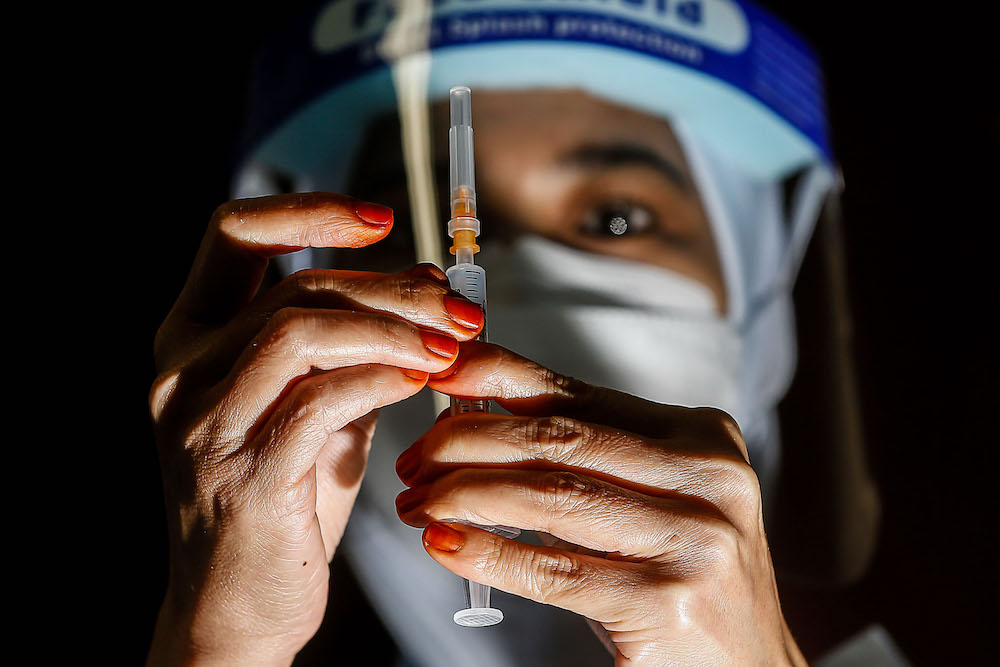 A nurse prepares the vaccine during the vaccination session for Persons with Disabilities in St Nicholas Home, Bagan Jermal July 5, 2021. u00e2u20acu201d Picture by Sayuti Zainudin