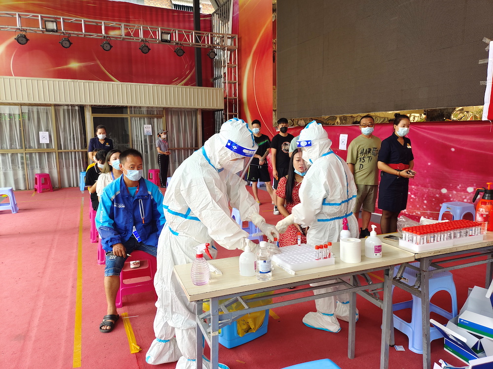 People line up for nucleic acid testing at a residential compound following new cases of Covid-19 in Ruili, a border city with Myanmar, in Yunnan province, China July 5, 2021. u00e2u20acu201d cnsphoto via Reuters