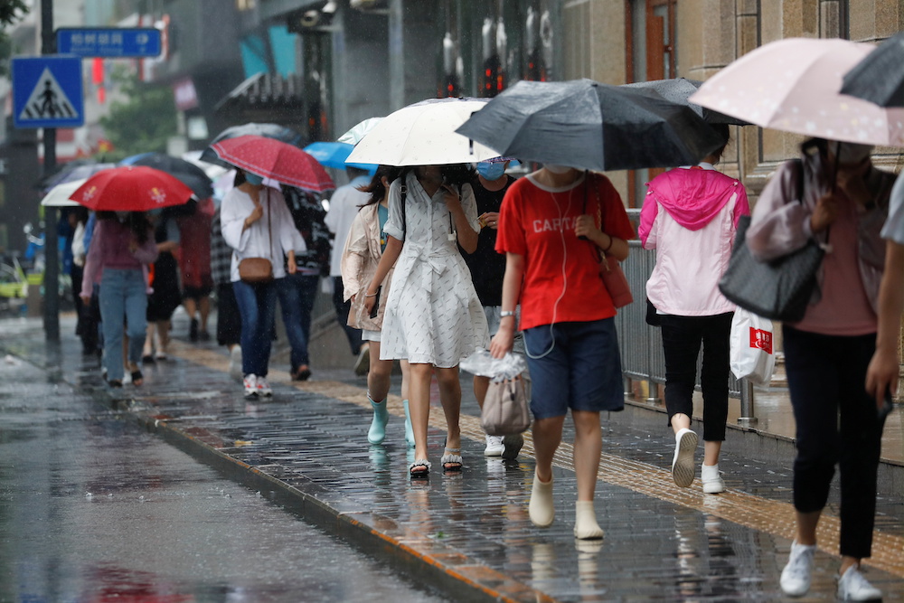 People carrying umbrellas walk on a street during a rainy day in Beijing, China July 12, 2021. u00e2u20acu201d Reuters pic