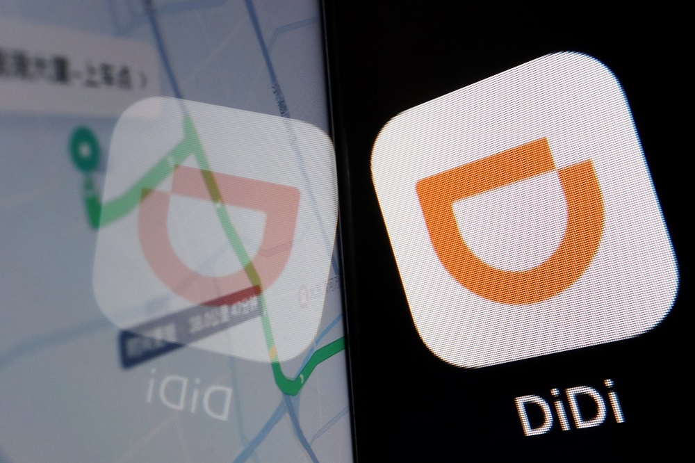 The app of Chinese ride-hailing giant Didi is seen on a mobile phone in front of the company logo displayed in this illustration picture taken July 1, 2021. u00e2u20acu201d Reuters pic