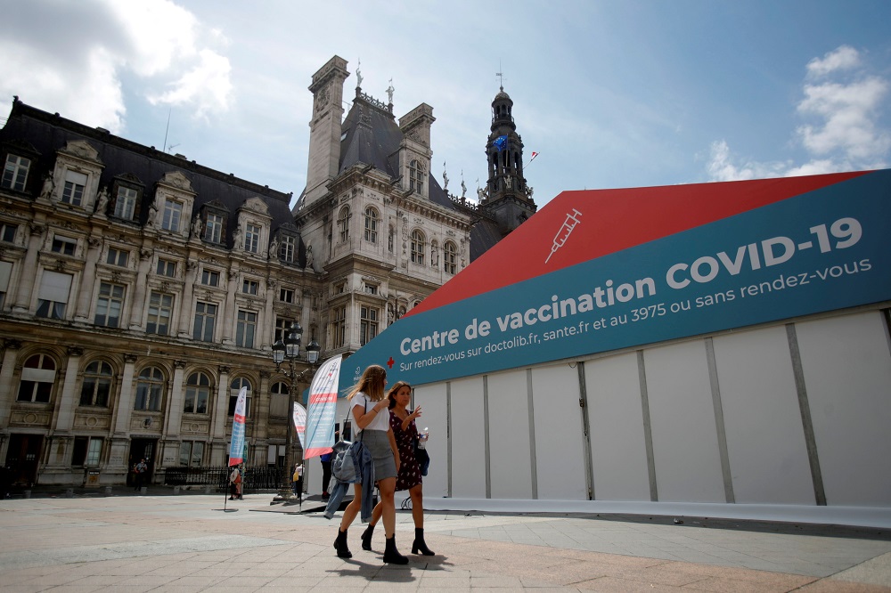 Women walk past a coronavirus disease vaccination centre installed in front of Paris town hall in France July 7, 2021. u00e2u20acu201d Reuters pic