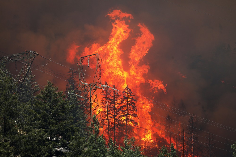 Power lines are framed by flames as the Dixie Fire grows in Plumas National Forest, California July 15, 2021. u00e2u20acu201d Reuters pic