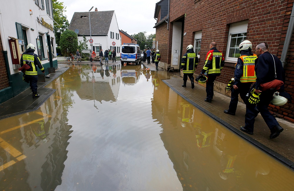Firefighters walk a flooded street following heavy rainfalls in Erftstadt-Blessem, Germany July 16, 2021. u00e2u20acu201d Reuters pic