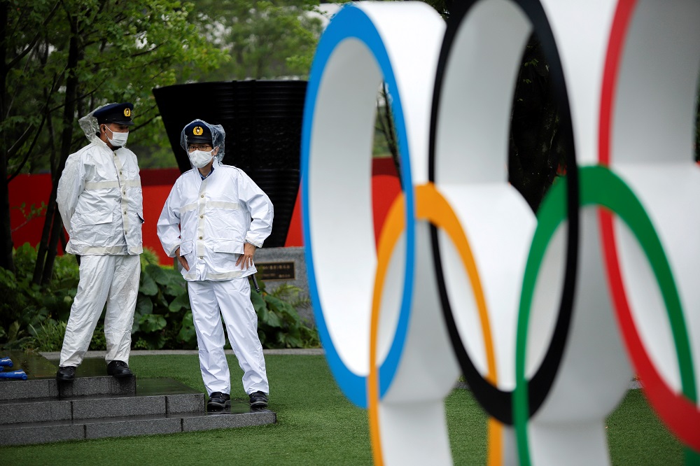 Policemen stand near the Olympic Rings outside the Olympic stadium in a calmer moment of tropical storm Nepartak in Tokyo July 27, 2021. u00e2u20acu201d Reuters pic