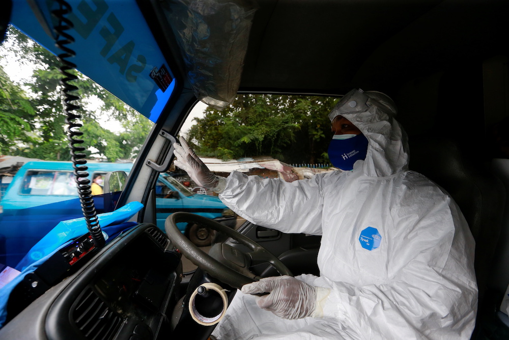 Sunaryo, 53, drives an ambulance as he delivers a patient suffering from coronavirus disease (Covid-19), as cases surge in Depok, on the outskirts of Jakarta, Indonesia, July 13, 2021. u00e2u20acu201d Reuters pic 