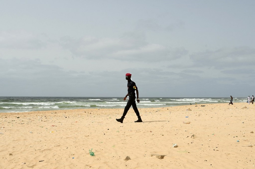 A Senegal’s police officer patrols on Malika beach in Dakar on July 4, 2021. — AFP pic