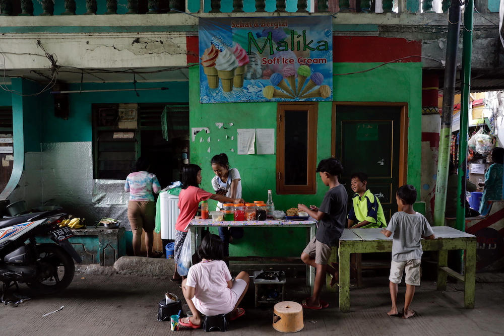 Children gather at a street-food shop at the Muara Baru neighborhood, amid the the spread of coronavirus disease (COVID-19) disease in Jakarta, Indonesia, July 14, 2021. u00e2u20acu201d Reuters pic