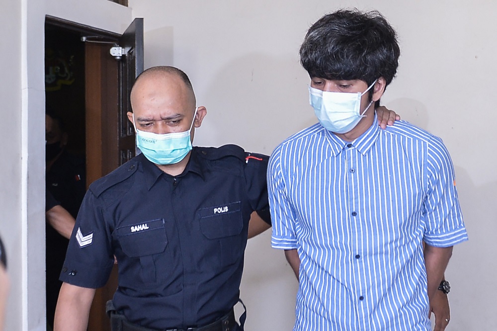 u00e2u20acu02dcBabiu00e2u20acu2122 film producer, Toh Han Boon (right), arrives at the Petaling Jaya Magistrate Court July 21, 2021. u00e2u20acu201d Picture by Miera Zulyana