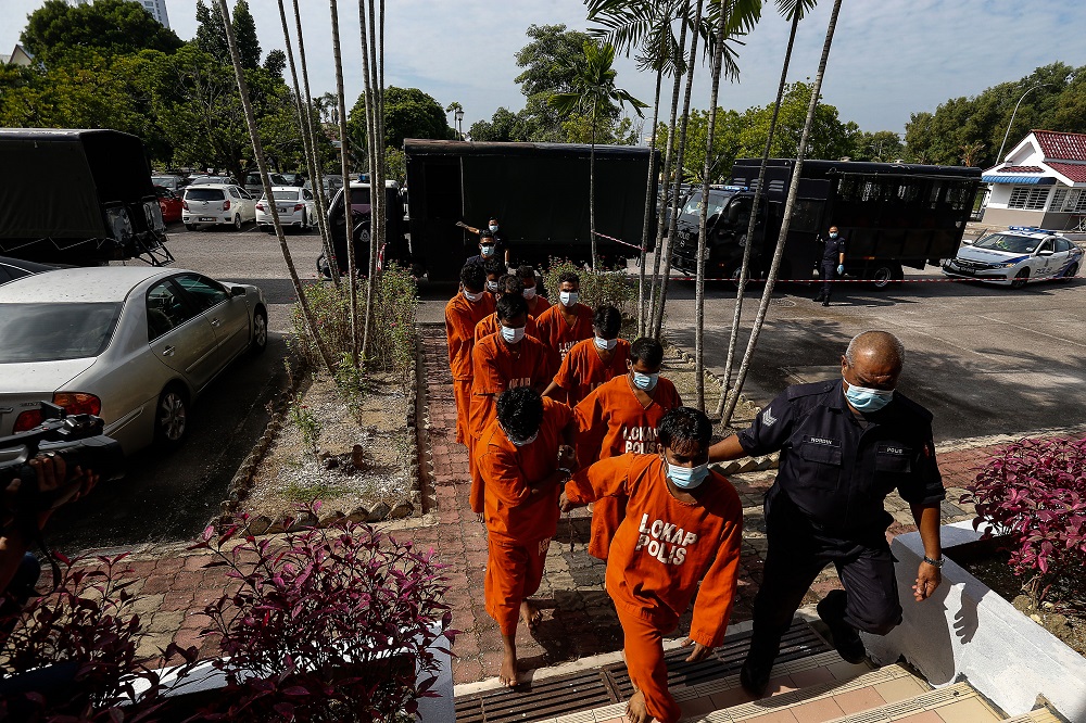 A group of men are led to the Bukit Mertajam Court to be remanded after a video clip of them performing Aidiladha prayers outside the Taman Pelangi Surau in Juru went viral on social media, July 21, 2021. u00e2u20acu201d Picture by Sayuti Zainudin