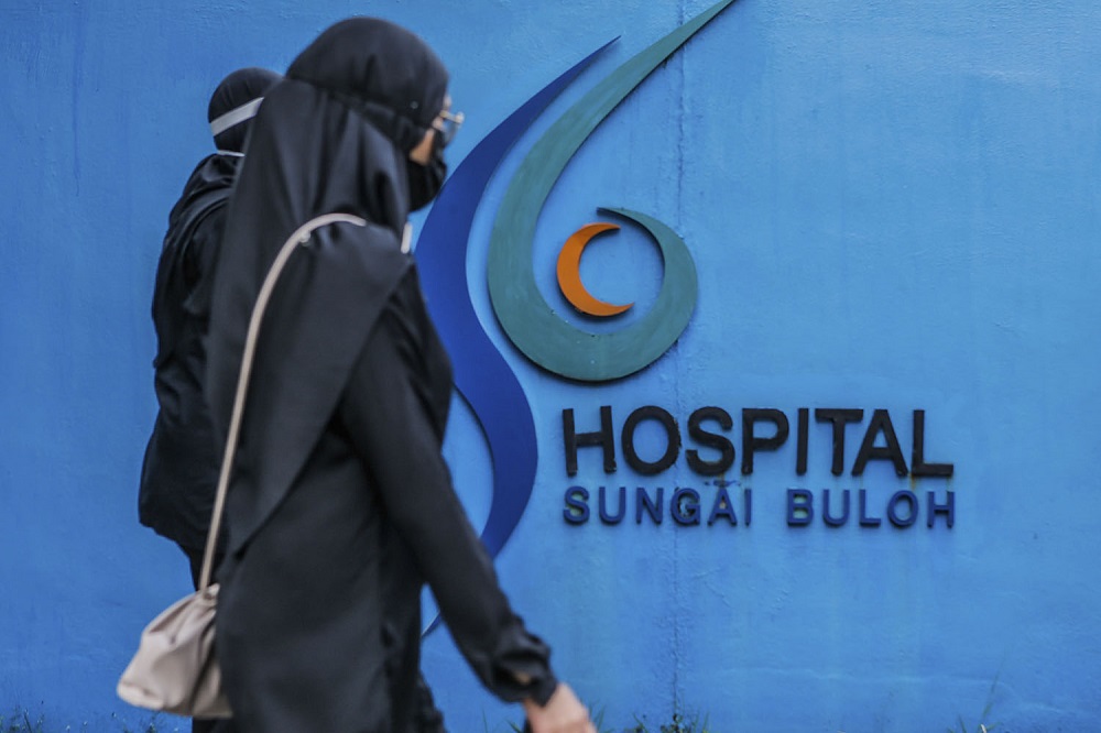 Doctors clad in black are seen outside the Sungai Buloh Hospital during a strike July 26, 2021. — Picture by Hari Anggara 