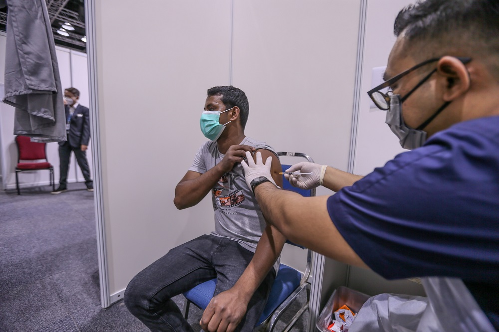 A foreign worker receives a dose of Covid-19 vaccine at the KLCC vaccination centre July 27, 2021. u00e2u20acu201d Picture by Ahmad Zamzahuri
