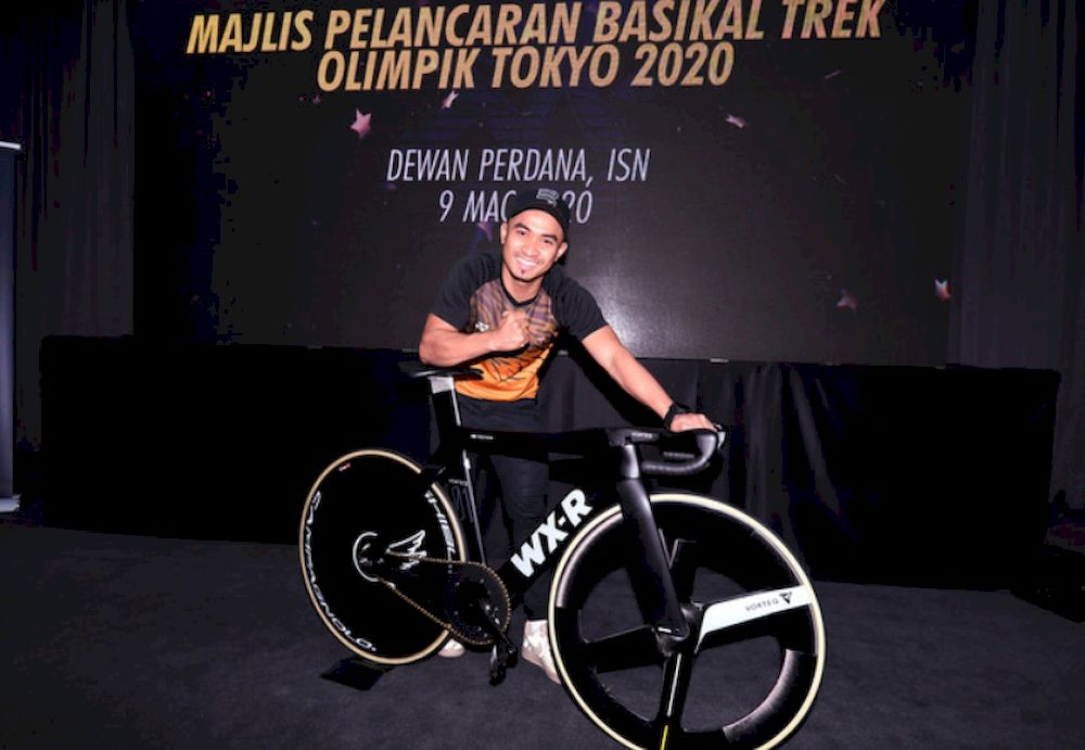 National cycling champion Mohd Azizulhasni Awang posing with the Tokyo 2020 Olympic track bike after its launching ceremony at the National Sports Institute March 9, 2020. u00e2u20acu201d Bernama pic