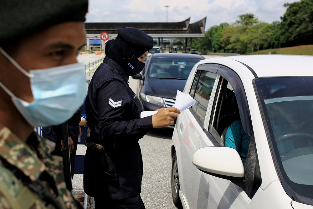 Police and Armed Forces personnel conduct a check on vehicles at a roadblock at the Seremban Toll Plaza near Port Dickson July 10, 2021. u00e2u20acu201d Bernama pic
