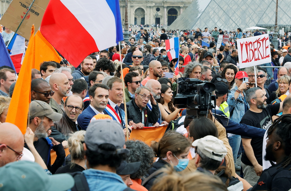 Florian Philippot, President of French political party Les Patriotes, and Nicolas Dupont-Aignan, head of French political party Debout La France (DLF) attend a protest against the new measures announced by French President Emmanuel Macron to fight the COV
