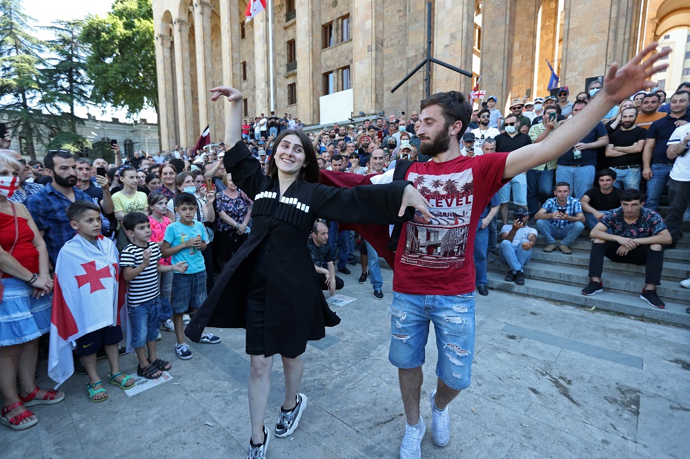 People dance in front of the parliament building as they celebrate after LGBT+ campaigners called off plans to stage the March for Dignity during Pride Week in Tbilisi, Georgia July 5, 2021. u00e2u20acu2022 Reuters pic