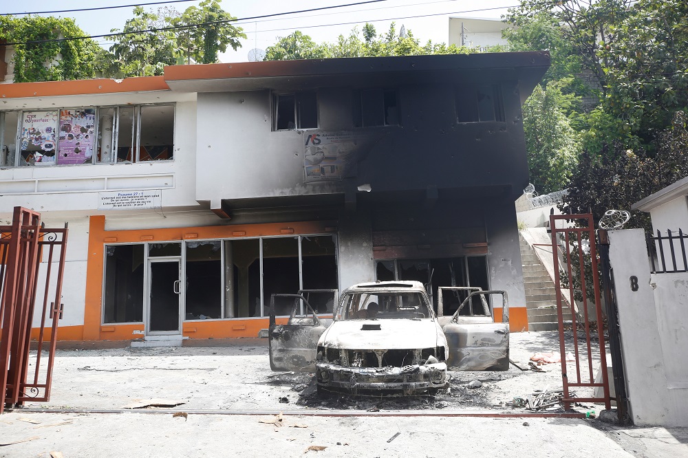A car is seen outside a house, both set on fire by locals after a firefight between police and the suspected assassins of President Jovenel Moise who was shot dead early Wednesday at his home, in Port-au-Prince, Haiti July 8, 2021. u00e2u20acu2022 Reuters pic