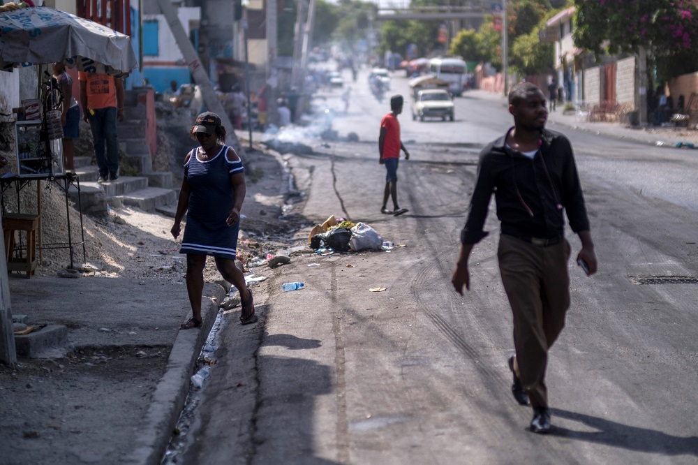 People walk on a street after tyres were set on fire by protesters upset with growing violence in the Lalue neighbourhood, a week after the assassination of President Jovenel Moise, in Port-au-Prince, Haiti July 14, 2021. u00e2u20acu2022 Reuters pic