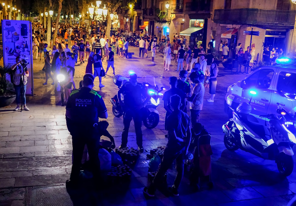 Police officers confiscate beer cans that street vendors sell to tourists and locals gathering on a street in the Born neighbourhood, as indoor nightlife venues were shut again in Barcelona, Spain, July 10, 2021. u00e2u20acu2022 Reuters pic