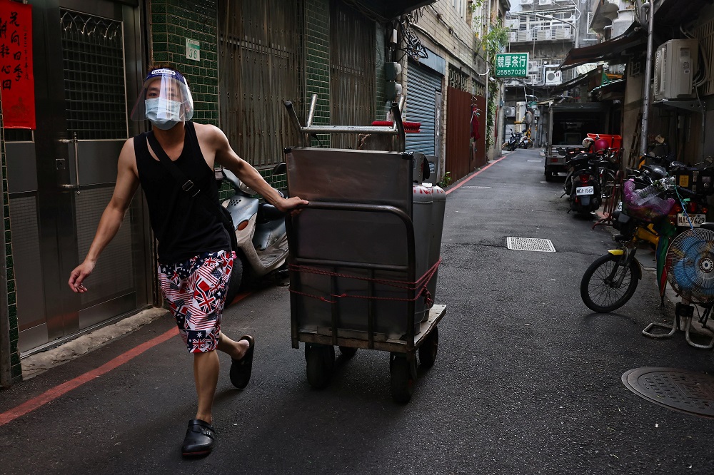 A person wearing a protective face masks pushes his stall ready for the reopening of a night market amid the Covid-19 pandemic in Taipei, Taiwan June 30, 2021. u00e2u20acu2022 Reuters pic