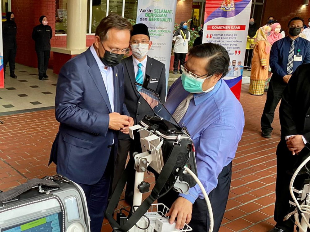 Johor Mentri Besar Datuk Hasni Mohammad (left) being briefed on the ventilators after the handing over ceremony of the machines at the Sultanah Aminah Hospital in Johor Baru July 7, 2021 u00e2u20acu201d Picture by Ben Tannn