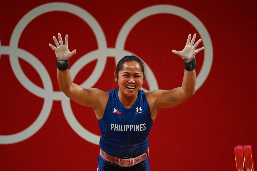 Philippinesu00e2u20acu2122 Hidilyn Diaz reacts after placing first in the womenu00e2u20acu2122s 55kg weightlifting competition during the Tokyo 2020 Olympic Games at the Tokyo International Forum in Tokyo July 26, 2021. u00e2u20acu201d AFP picnn