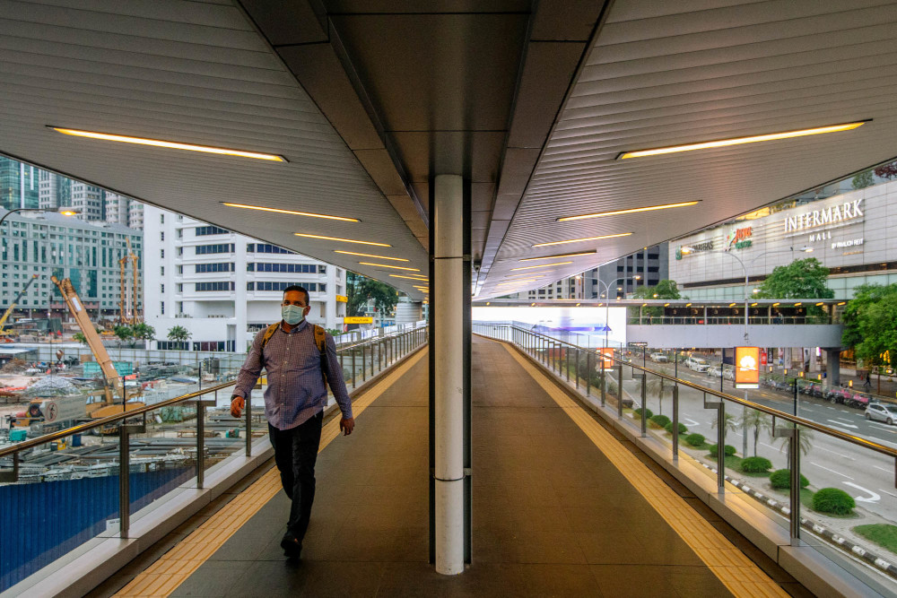 A pedestrian walks along an elevated walkway in Kuala Lumpur July 1, 2021. u00e2u20acu201d Picture by Firdaus Latif 
