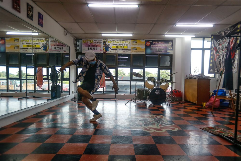 Streetdancer Low Sawming busts a move at his dance studio in Bagan Jermal during an interview with Malay Mail July 9, 2021. 
