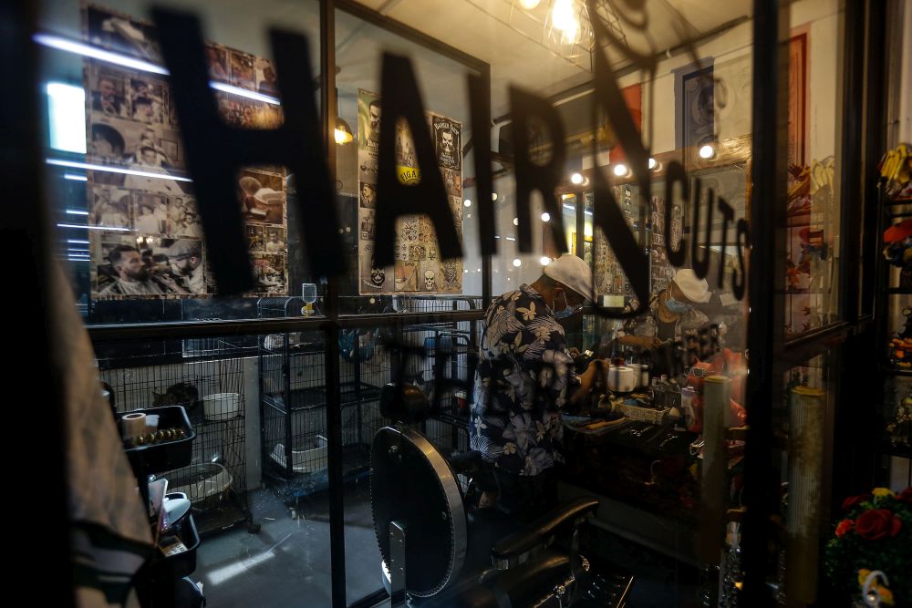Streetdancer Low Sawming cleans his tools at his hair studio in Bagan Jemal during an interview with Malay Mail July 9, 2021. 