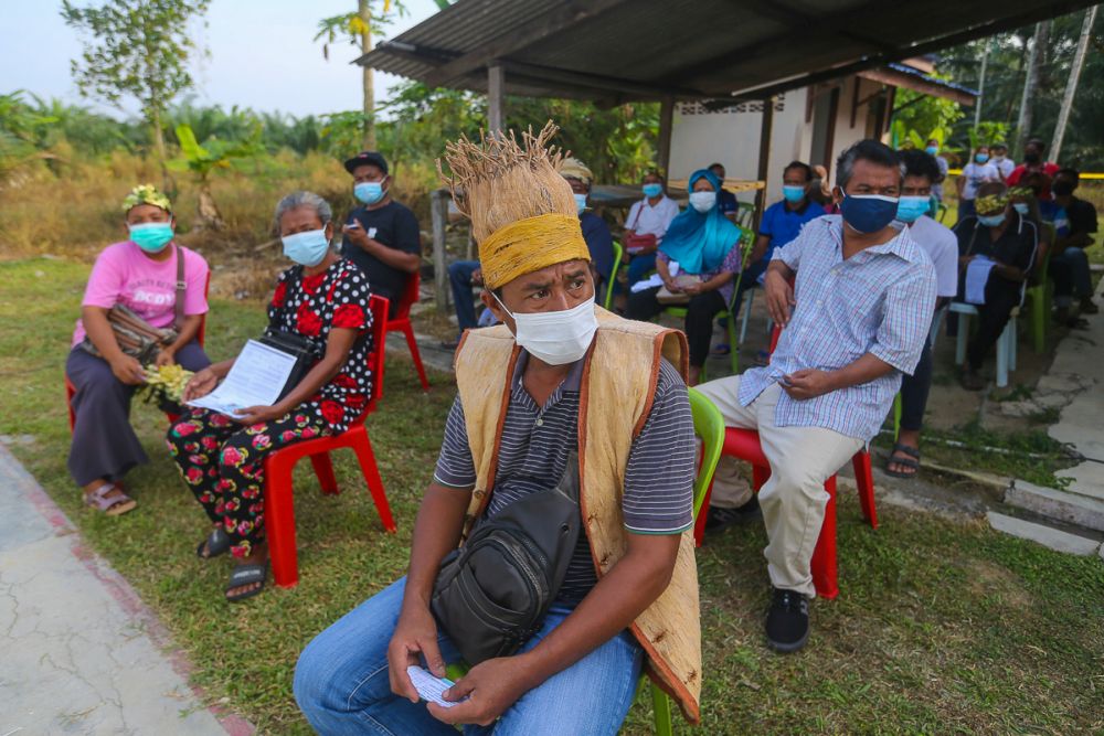People from the Orang Asli community wait to receive their Covid-19 jab in Jenjarom July 29, 2021. u00e2u20acu201d Picture by Yusof Mat Isa