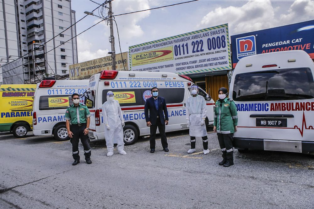 Paramedic EMS Services Sdn Bhd general manager and chief paramedic Faizal Nurdin (centre) and his staff pose for the camera at the companyu00e2u20acu2122s headquarters in Kuala Lumpur July 5, 2021. u00e2u20acu201d Picture by Hari Anggara