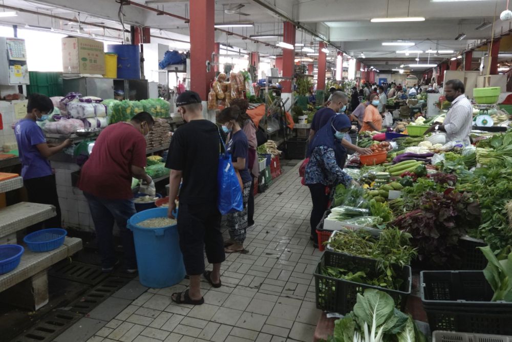 People shop for fresh produce at the Jalan Othman Wet Market, Petaling Jaya ahead of the enhanced movement control order on July 2, 2021. — Picture by Miera Zulyana