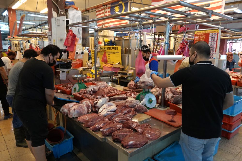 People shop for fresh meat at the Jalan Othman Wet Market, Petaling Jaya ahead of the enhanced movement control order on July 2, 2021. u00e2u20acu201d Picture by Miera Zulyanan