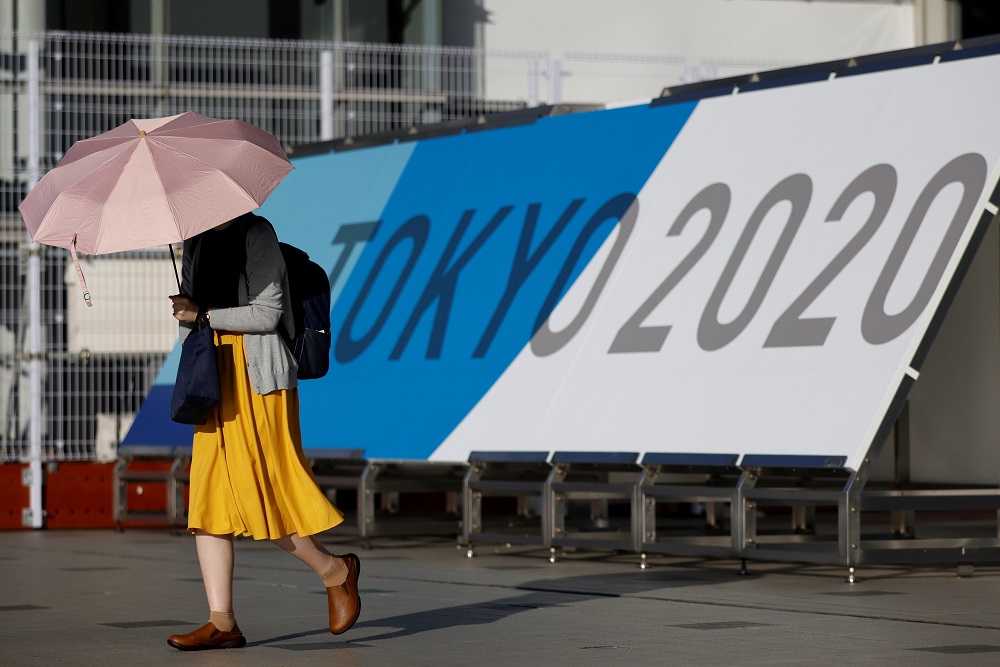 A woman walks past Tokyo 2020 Olympic Games signage at the Main Press Centre in Tokyo, Japan July 16, 2021. u00e2u20acu2022 Reuters pic