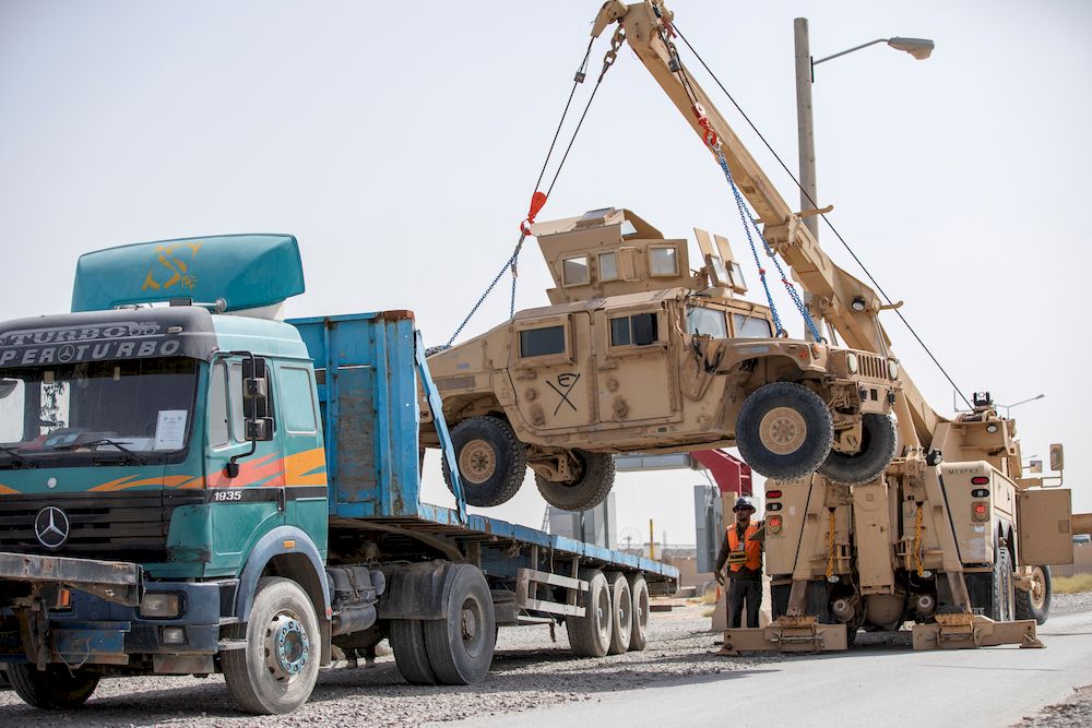 US Army soldiers and contractors load High Mobility Multi-purposed Wheeled Vehicles, HUMVs, to be sent for transport as US forces prepare for withdrawal, in Kandahar, Afghanistan, July 13, 2020. u00e2u20acu201d US Army/Sgt. Jeffery J. Harris/Handout via Reuters