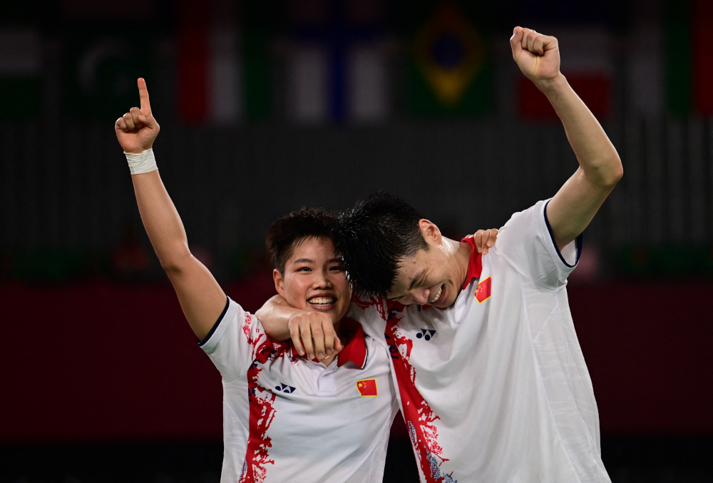 Chinau00e2u20acu2122s Huang Dongping and Wang Yilyu (right) celebrate winning the mixed doubles badminton final match against Chinau00e2u20acu2122s Zheng Siwei and Huang Yaqiong at the Musashino Forest Sports Plaza in Tokyo July 30, 2021. u00e2u20acu201d AFP picnn
