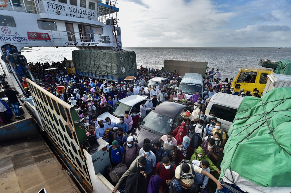 People wait to disembark from a ferry in Sreenagar on July 31, 2021 after they return to their work areas as Bangladesh relaxed the lockdown norms for all export-oriented factories earlier imposed to curb the spread of Covid-19. u00e2u20acu201d AFP pic