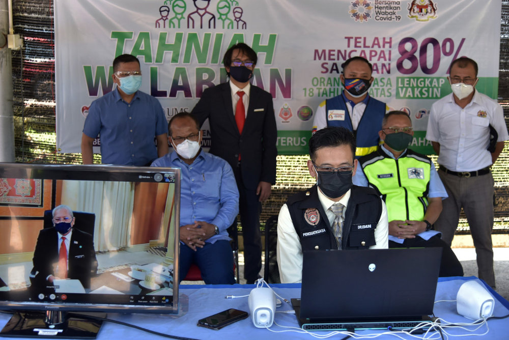 Federal Territories Minister Tan Sri Annuar Musa in a live virtual session with Labuan Health director Dr Ismuni Bohari (front) and Labuan District Disaster Management Committee chairman Rithuan Ismail in Labuan, July 27, 2021. u00e2u20acu201d Bernama pic 