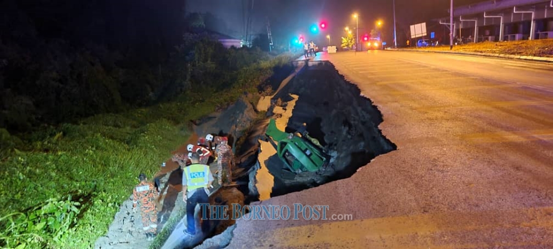 Fire and Rescue personnel at the scene of the accident where the road has caved in near Bau. u00e2u20acu2022 Picture courtesy of Fire and Rescue Department (Bomba)