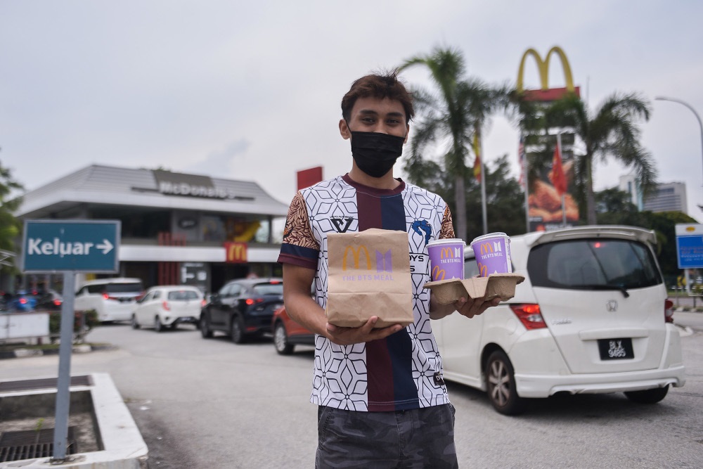 A customer posing with his BTS Meal at the McDonald’s outlet in Seksyen 3, Shah Alam on May 26, 2021. — Picture by Miera Zulyana