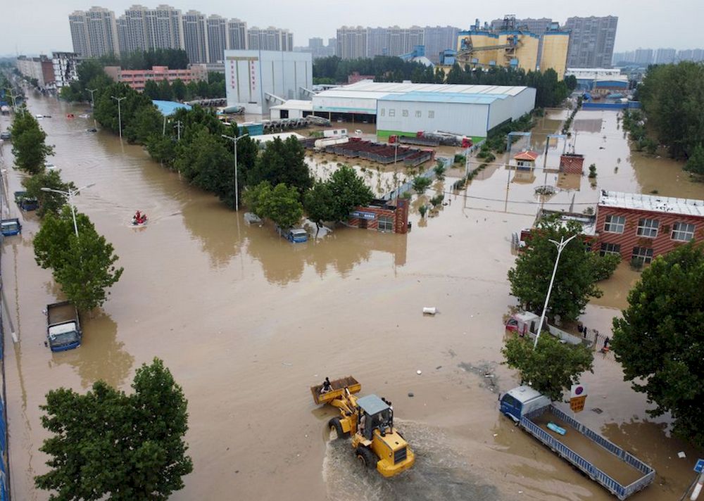 An aerial view shows rescue workers evacuating residents on a flooded road following heavy rainfall in Zhengzhou, Henan province, China July 22, 2021. u00e2u20acu201d  Reuters file pic