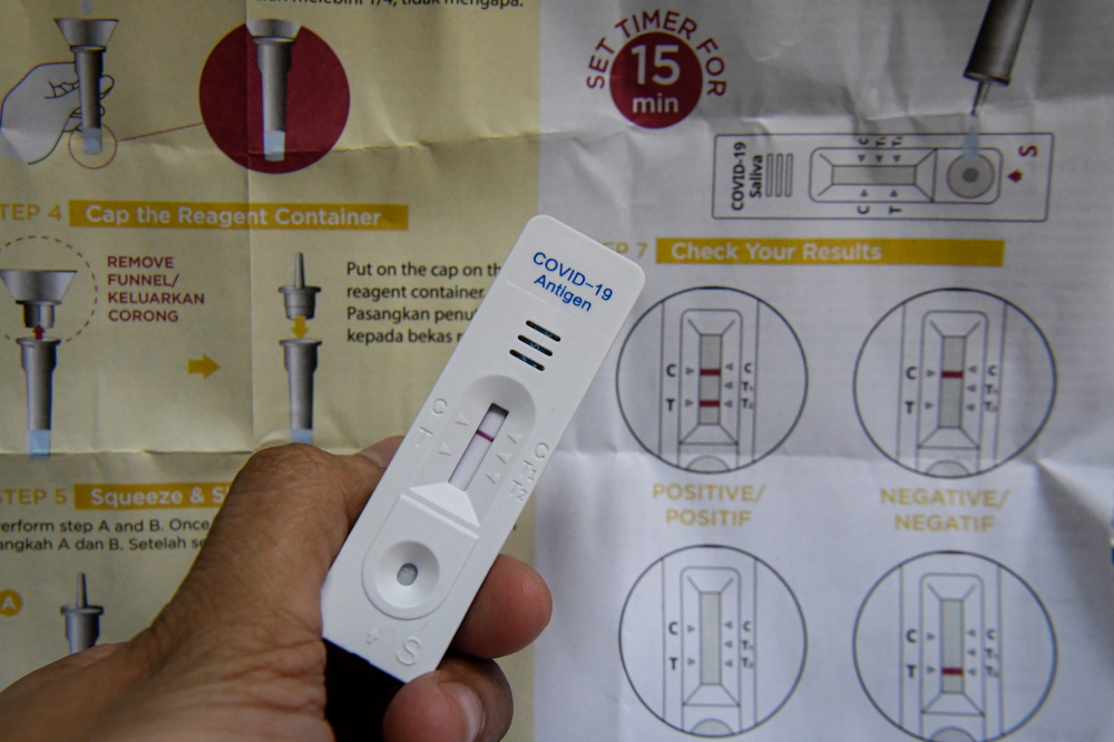 A negative result is shown after a 15-minute wait from the use of the Korean-made GMate Covid-19 Ag Saliva Home Kit, which can now be purchased at a CareMax Pharmacy in Setapak. u00e2u20acu201d Bernama pic 