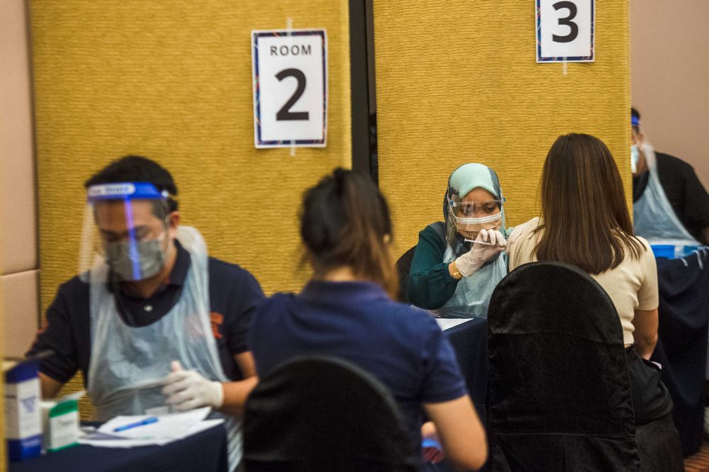People receive their Covid-19 jabs at the Eastin Hotel in Petaling Jaya July 23, 2021. u00e2u20acu201d Picture by Shafwan Zaidon