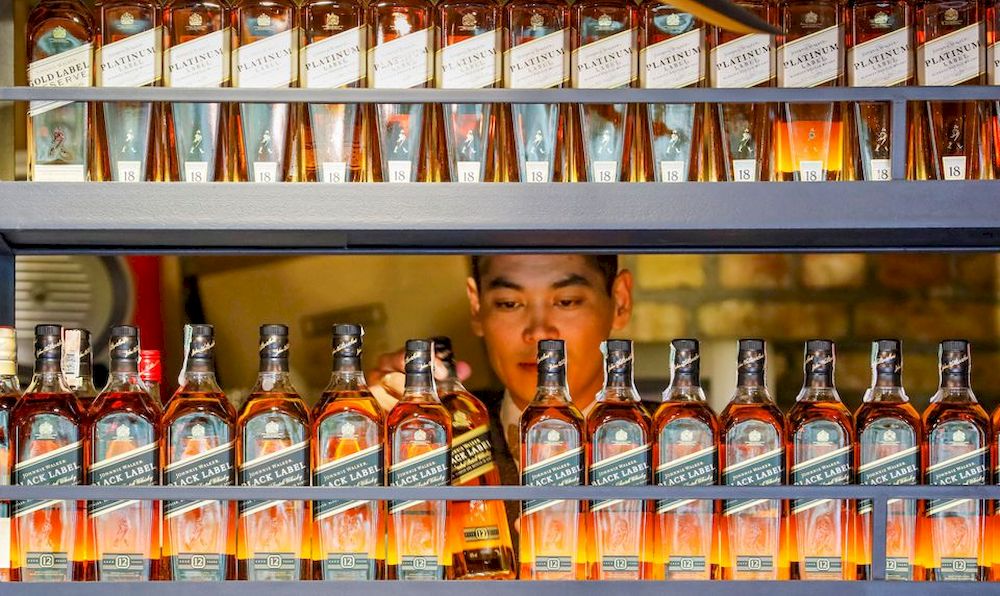 A bartender takes a bottle of Johnnie Walker whisky in Almaty, Kazakhstan June 22, 2017. u00e2u20acu201d Reuters pic