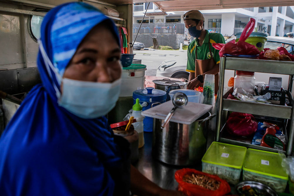 Cendol seller, Rosnah Sofian, 50, (left) and Mohd Aiman Firdaus 18 speak to Malay Mail during an interview at UTC Sentul July 2, 2020. — Picture by Hari Anggara