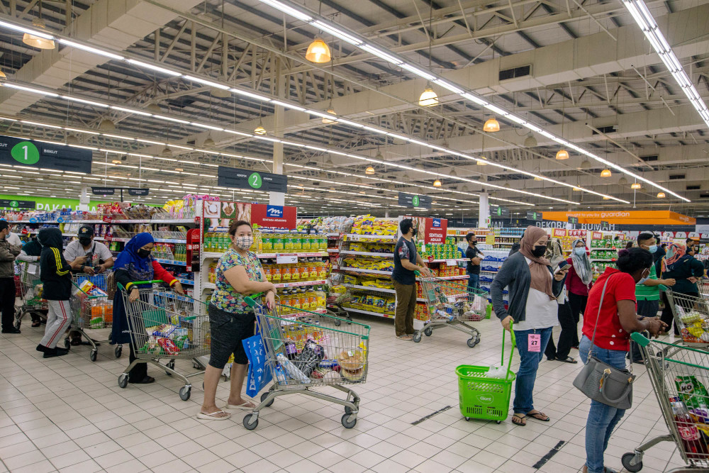 People buy groceries at a supermarket ahead of the enhanced movement control order (EMCO) in Gombak, Selangor July 2, 2021. — Picture by Firdaus Latif