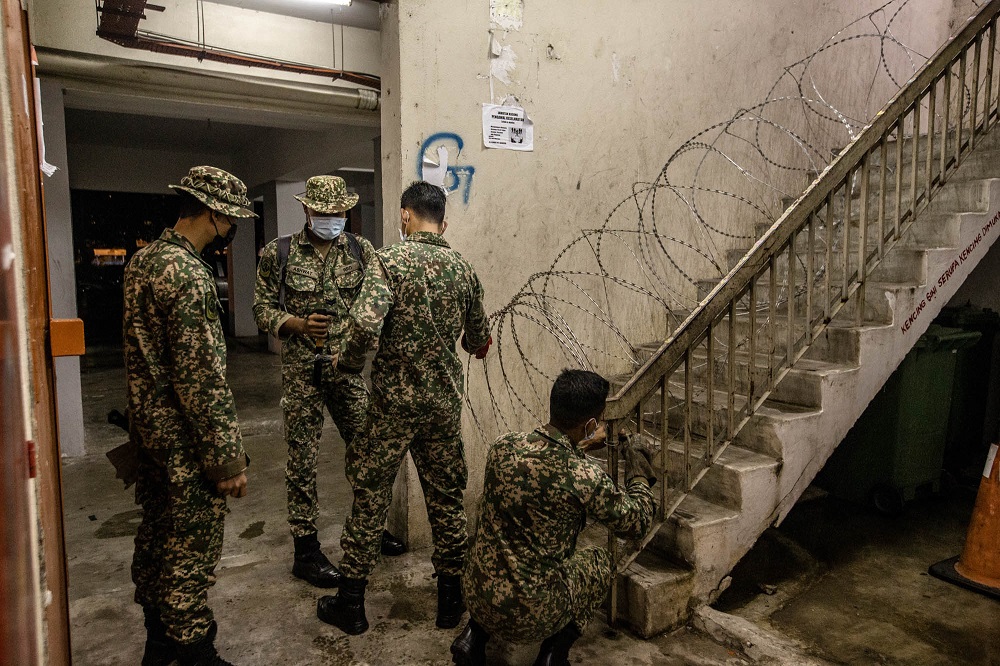 Armed Forces personnel install barbed wire fencing at PPR Kampung Baru Air Panas Block C during the enhanced movement control order (EMCO) in Kuala Lumpur July 3, 2021. u00e2u20acu2022 Picture by Firdaus Latif